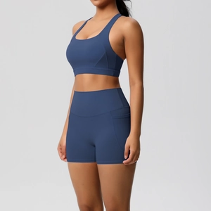 Close-up of high-waisted navy yoga shorts with functional side pockets and elastic fabric