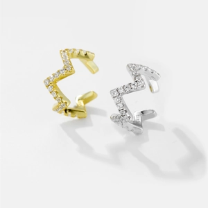 Detailed macro view of S925 sterling silver ear cuffs with cubic zirconia in gold and silver