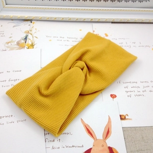 Knitted ribbed twist headband for children in yellow, minimalist stretch hair accessory