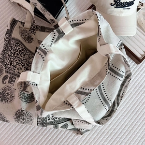 Detail view of the cotton linen tote bag showing interior pocket and paisley floral pattern
