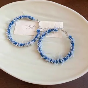 Bohemian C-shaped hoop earrings wrapped in blue and white denim fabric tassels