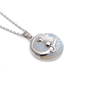 Detail of silver crescent moon necklace with cat silhouette and opal stone inlay