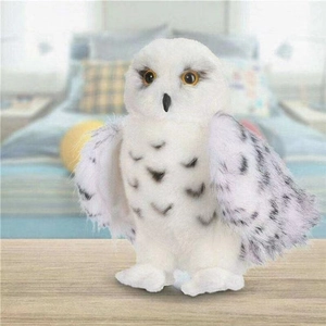 Detail of white snowy owl plush toy with soft fur texture and realistic yellow eyes