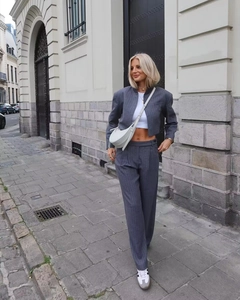 Detail view of charcoal gray pinstripe suit set with cropped jacket and wide-leg trousers