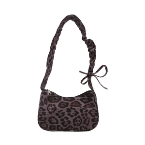 Vintage leopard print shoulder bag with plush fabric and a stylish bow tied strap