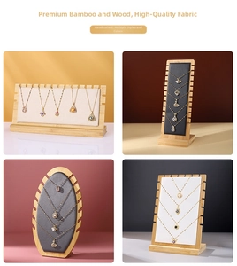 Bamboo necklace display board with multiple slots in beige, gray, and black fabric textures