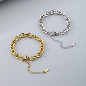 Macro detail of K18 engraved tag on gold and silver Cuban chain bracelets with lobster clasp