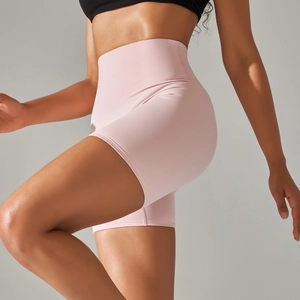 Close-up of pink high-waisted yoga shorts with elastic tummy control and lifting seams