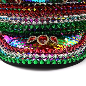 Detail of sequins and metallic studs with red heart gemstones on the party captain hat