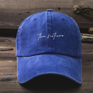 Close-up of the future white embroidery on a washed cobalt blue cotton baseball cap