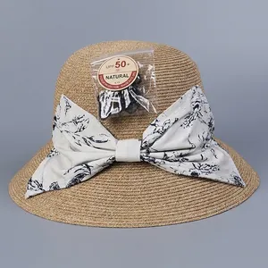 Elegant wide brim sun hat with floral bow and UPF 50+ protection for vacation