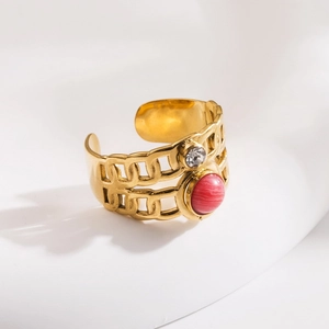 Detail of gold open ring with double-row chain texture and pink natural stone inlay