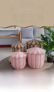 Detail of hand-woven paper rope basket showing pink striped texture and star lid handle