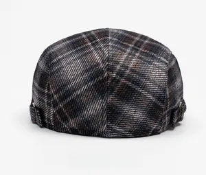 Detailed back view of a plaid newsboy hat with an adjustable metal buckle strap