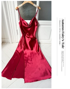 Detail view of red satin nightgown with delicate spaghetti straps and cowl neckline