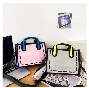 Detail of pink and grey 2D cartoon style canvas tote bags on a desk with laptop