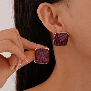 Vintage purple faux leather square earrings with golden frame on model profile
