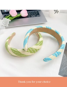 Detail of woven headband with blue and green striped texture on a desktop setting