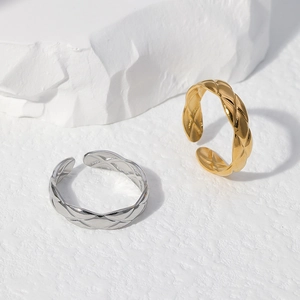Macro detail of gold and silver quilted pattern rings with adjustable open band design
