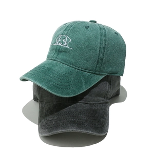 Detail of washed cotton baseball caps with vintage texture and cute dog embroidery art