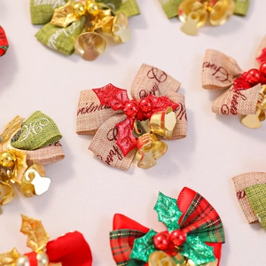 Detailed view of Christmas burlap bows with mini golden bells and holly berry accents