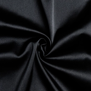 Close-up of sleek black satin fabric showing elegant drapes and smooth silk texture