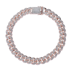 Macro shot of rose gold iced-out Cuban link necklace with crystal rhinestones