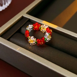 Macro shot of colorful transparent floral beaded ring on a dark jewelry display tray