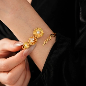 Detail of vintage flower bracelet with pearls and zircons on a model in black velvet