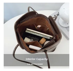 Internal capacity of brown leather tote bag showing pockets and storage space