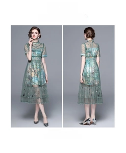 Close-up of embroidered floral patterns and beadwork on a mesh short sleeve maxi dress