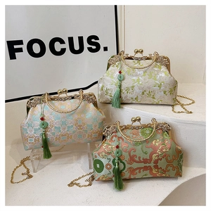 Detailed view of vintage embroidery handbags with silk tassels and metal chain straps