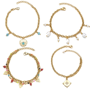 Vintage gold bracelets featuring evil eye, baroque pearls, beads, and star charms