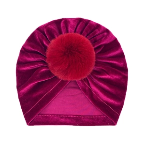 Detailed view of dark red velvet baby beanie with matching faux fur pompom top