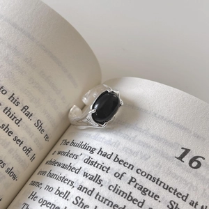 Elegant 925 sterling silver flower ring with black agate set in an open vintage book
