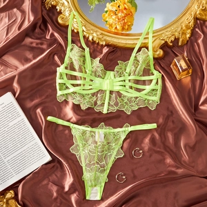Lace lingerie set in neon green floral embroidery displayed on elegant satin fabric