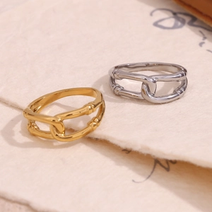 Detailed view of gold and silver chain rings on elegant textured parchment paper