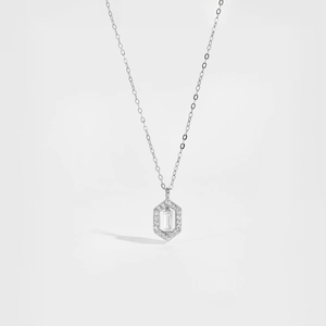 Detailed close-up of a silver hexagonal pendant with rectangular zircon on white background