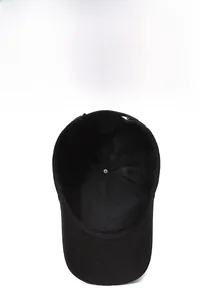Close-up of black baseball cap featuring breathable mesh back and reinforced stitching