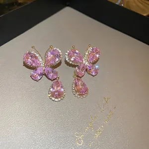 Pink crystal butterfly drop earrings with gold plating and cubic zirconia accents