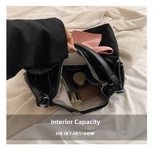 Top view detail of the internal capacity and light twill lining of this black suede bag