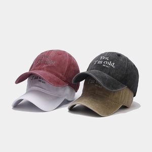Detail of four vintage washed baseball caps with embroidered Yes I'm cold lettering
