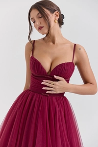 Detail of burgundy mesh dress showing slim-fit bodice and tiered tulle ruffles