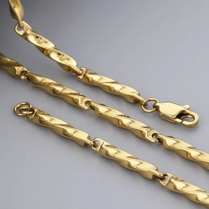Polished Mobius loop necklace in gold finish with durable stainless steel chain link