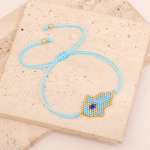 Handmade woven Hamsa Hand bracelet with blue evil eye beads and adjustable strap