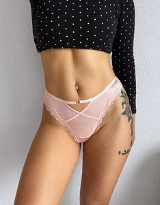 Detail shot of pink ice silk mesh thong with lace trim and heart charm on model