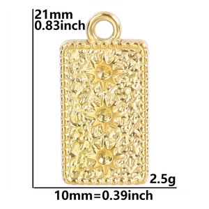 Detailed view of golden rectangular pendant with star motifs and hammered texture