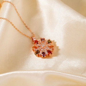 Exquisite rose gold necklace featuring a colorful zircon flower pendant on silk fabric