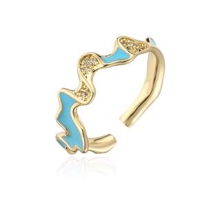 Macro detail of wave-shaped 18K gold-plated ring with sky blue enamel and zircons