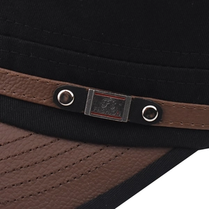 Detail of cotton military cap with leather strap, metal rivets and logo plaque